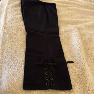 Pants with grommet detail